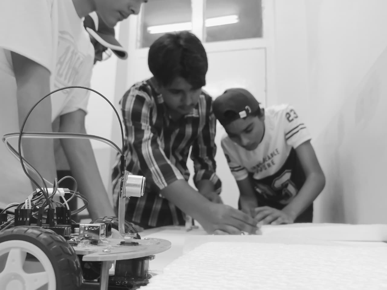 Students building a wheeled robot together