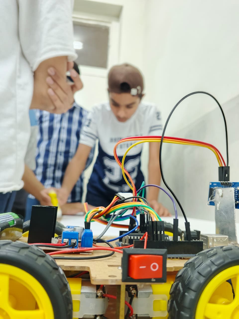 Students wiring a robot car